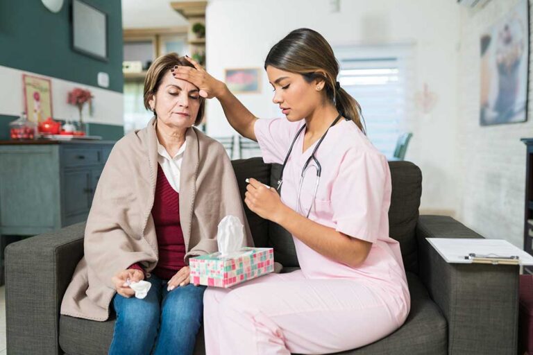 Adult child and aging parent reviewing a home care plan together at a kitchen table.